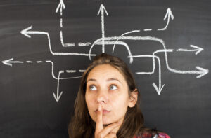 career CTO concept. Young woman ponders which direction to go in with arrows pointing in different directions behind her
