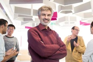 AI development concept. Professor Yoshua Bengio with his arms folded smiling at camera
